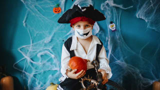 Little boy in pirate costume with mask